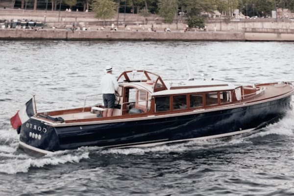 Corto boat ride on the Seine with a man steering the boat